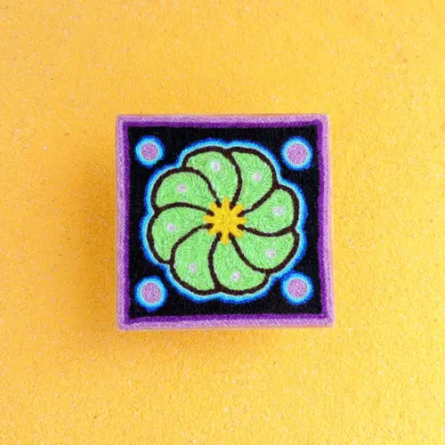 Handmade Huichol yarn painting showing a green peyote flower with blue dots, crafted with yarn and beeswax on a 10cm square wooden base. Front Image