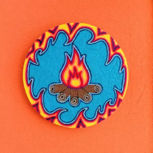 Handmade Huichol yarn painting showing the Fire God with bright flames and colorful borders, crafted with yarn and beeswax on a 20cm round wooden base. Front Image