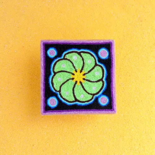 Handmade Huichol yarn painting showing a green peyote flower with blue dots, crafted with yarn and beeswax on a 10cm square wooden base. Front Image