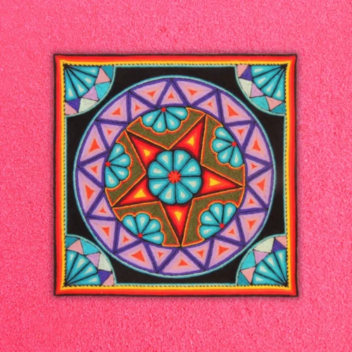Huichol yarn painting with peyote and star on pink background